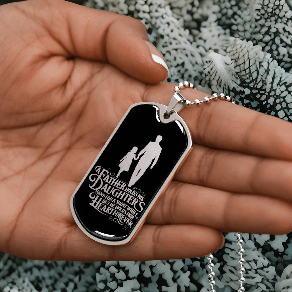 A father holds his daughter's hand