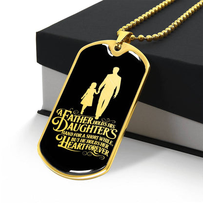 A father holds his daughter's hand